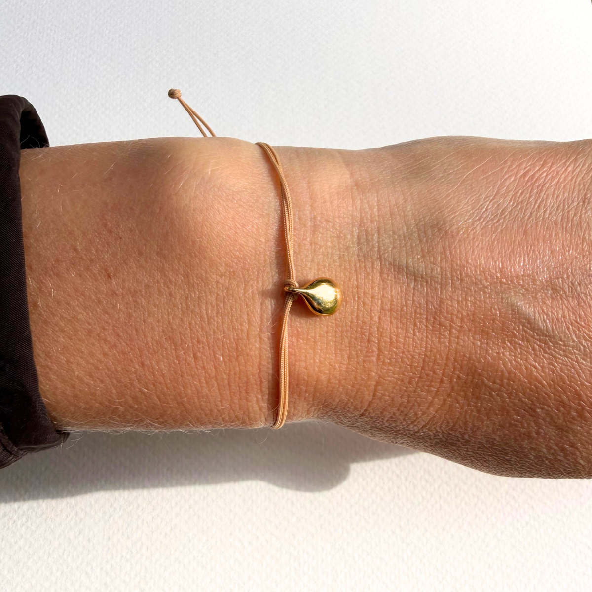Gyllen dråpe armbånd, beige nylonsnor med forgylt dråpe
